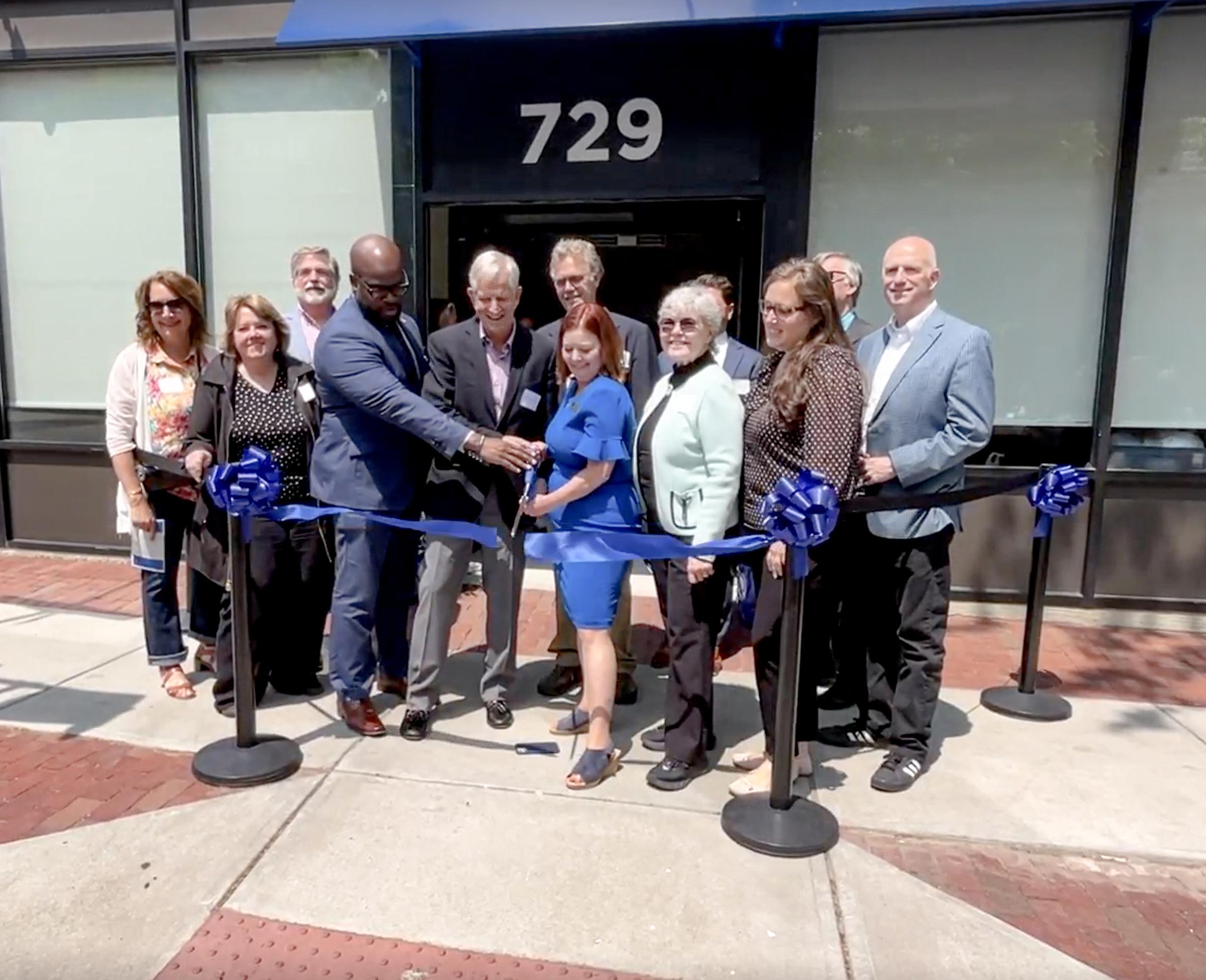 Quinebaug Valley staff watch on as Quinebaug Valley CEO Karen Hynick, Ed.D. cuts the ribbon with (right to left) Windam Mayor Tom DeVivo, Steven Townsend and CT State President John Maduko, M.D.